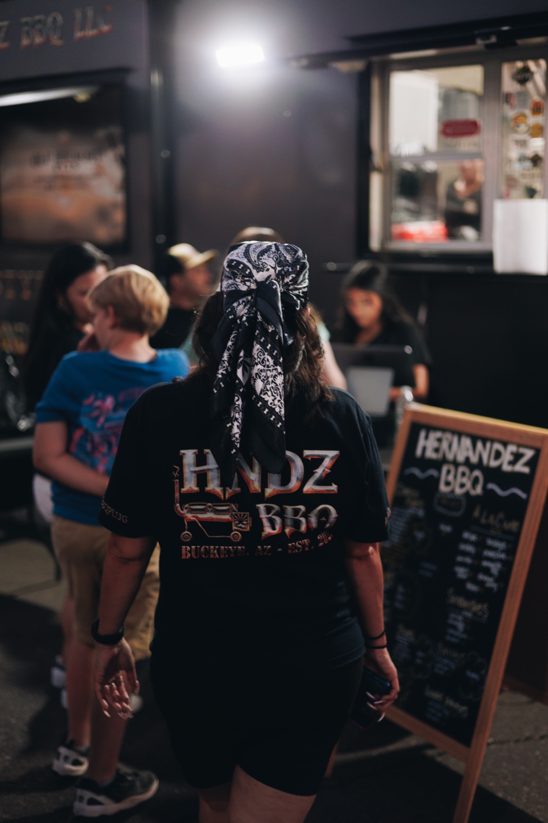 HNDZ BBQ team member serving customers at the truck