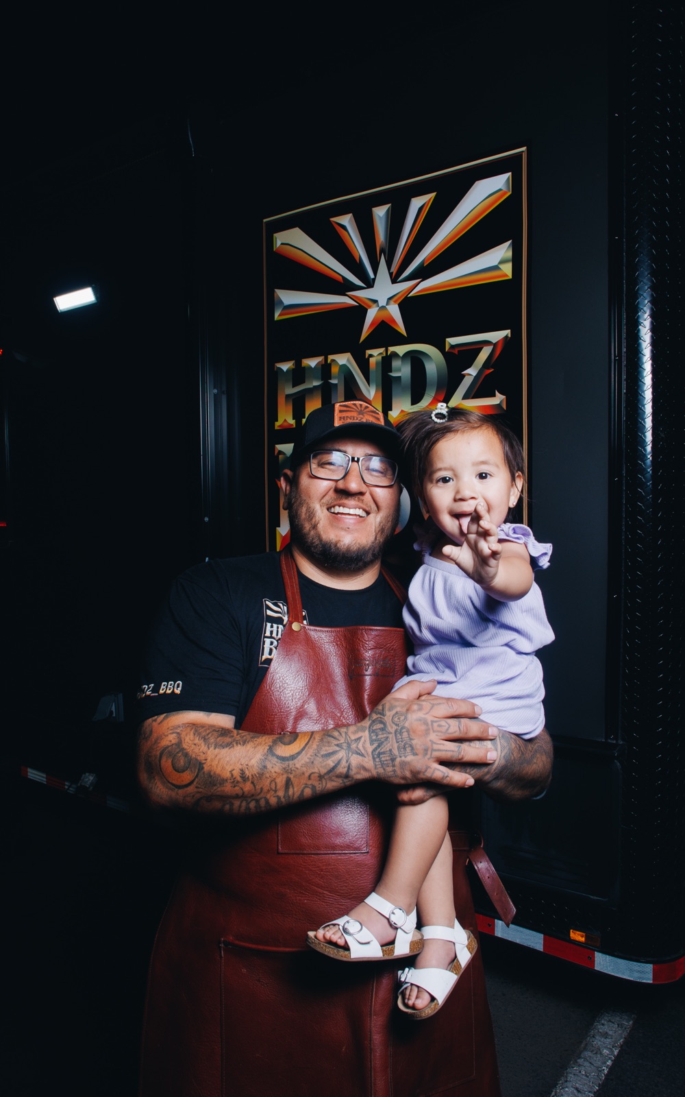 HNDZ BBQ pitmaster with his daughter in front of the food truck